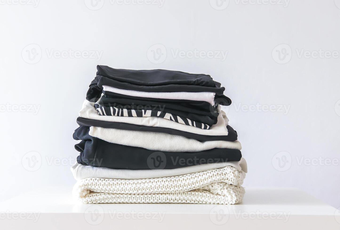 Stack of folded colorful clothes. Compact storage organizing photo