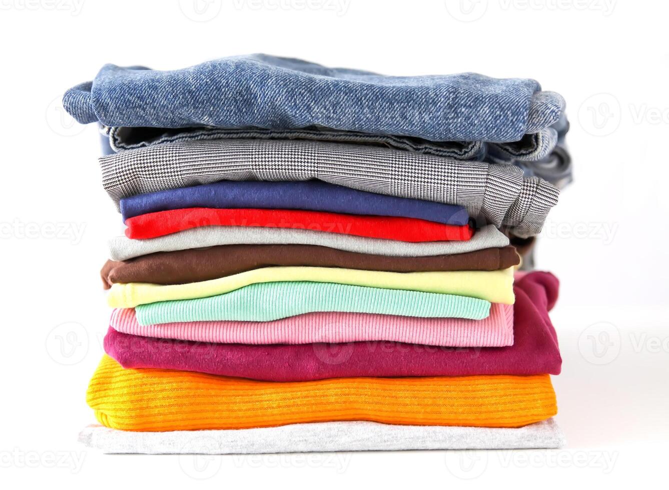 Stack of folded colorful clothes. Compact storage organizing photo