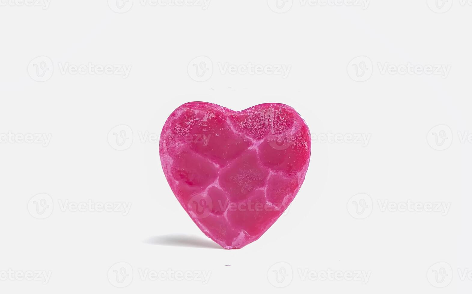 Heart shaped bar of soap on a light soft background. Top view. photo