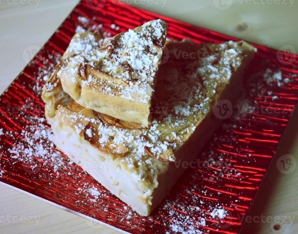 Homemade sweet apple pie with cinnamon and and powdered sugar. photo