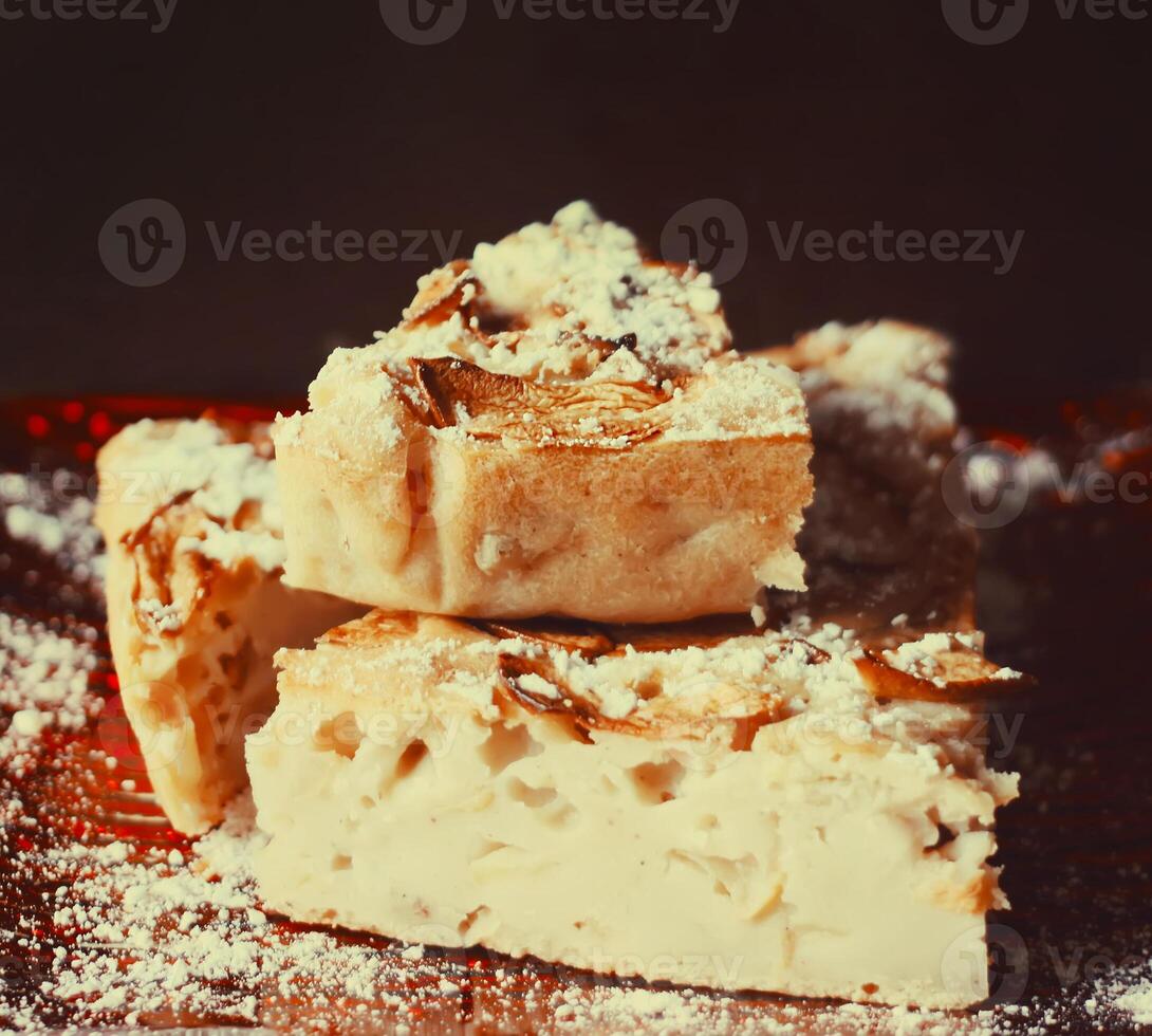 Homemade sweet apple pie with cinnamon and and powdered sugar. photo