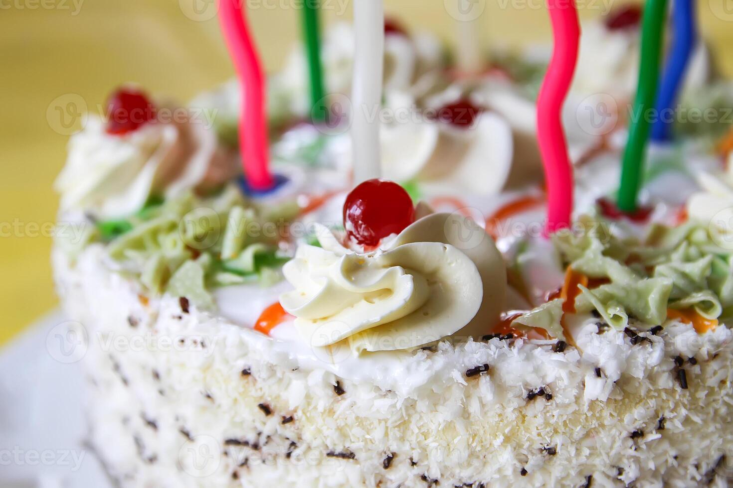 Traditional sweet birthday cake with colorful candles. photo