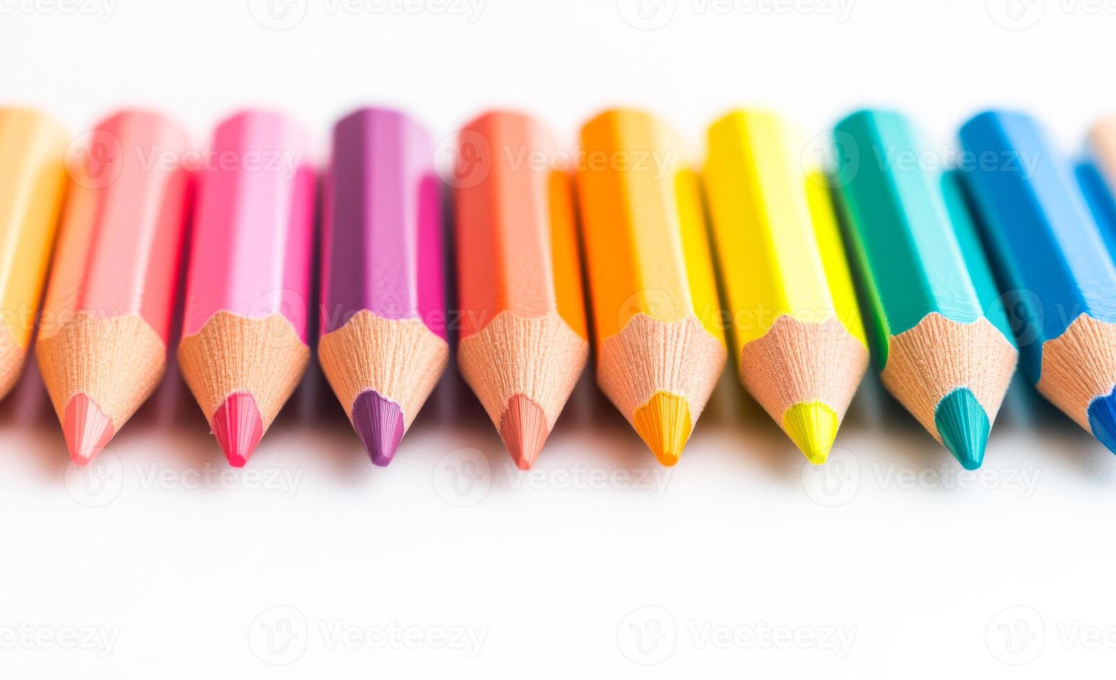A row of colored pencils are lined up on a white background. The pencils are of different colors and sizes, creating a vibrant and lively scene. Concept of creativity and artistic expression photo