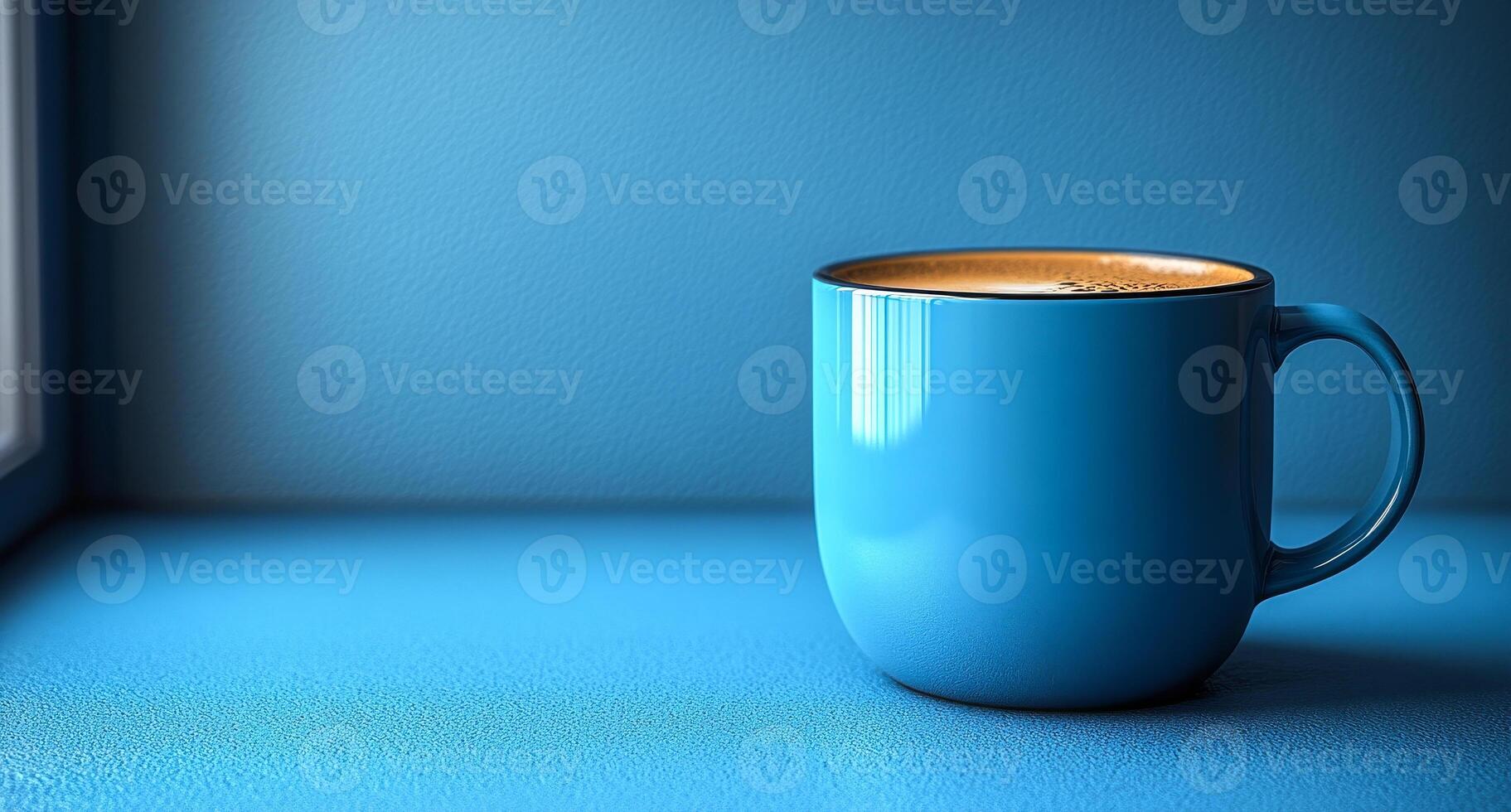 A blue coffee cup sits on a blue countertop. The cup is half full of coffee, and the liquid is swirling inside. Concept of calm and relaxation photo