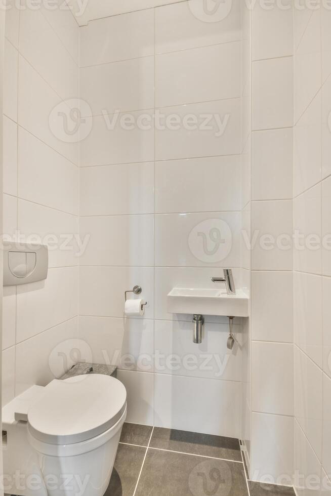 A white toilet in a bathroom photo