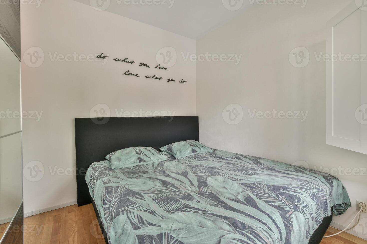 A bedroom with a bed and a wall mounted television photo