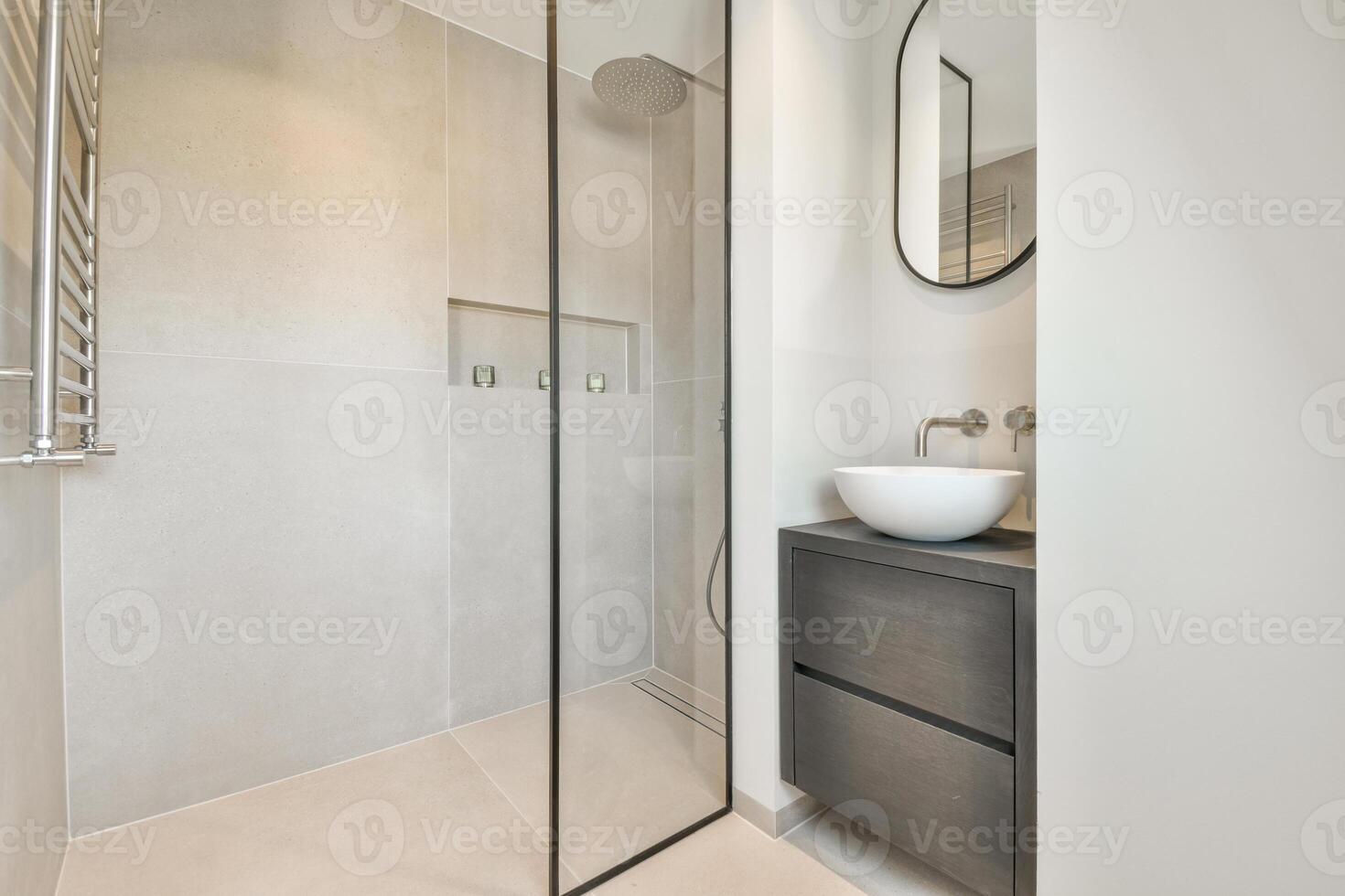 A modern bathroom with a glass shower door photo