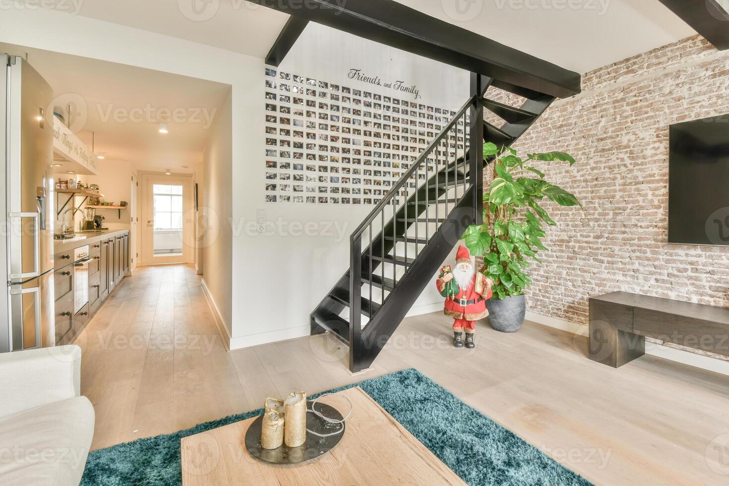A living room with a staircase and a brick wall photo