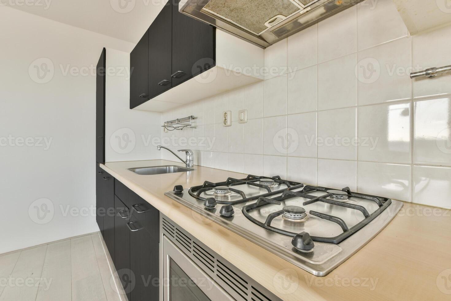 A kitchen with a stove and a sink photo