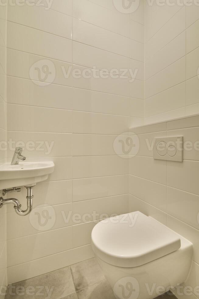 A white toilet sitting next to a sink in a bathroom photo
