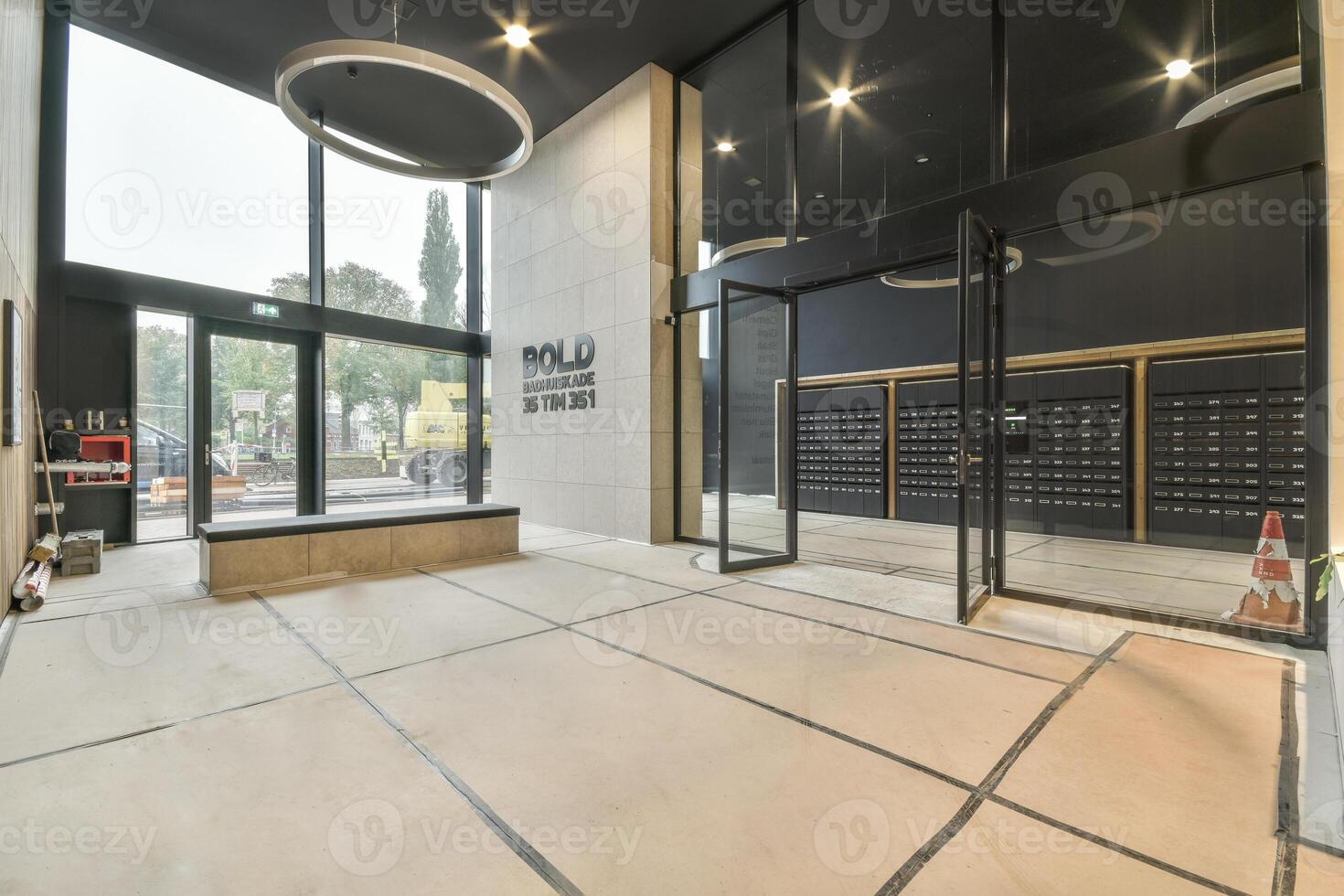An empty lobby with a large glass door photo