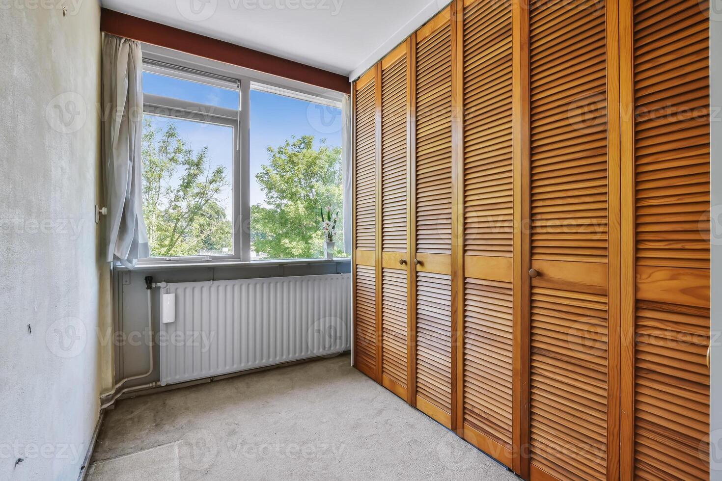 A room with wooden shutters and a window photo