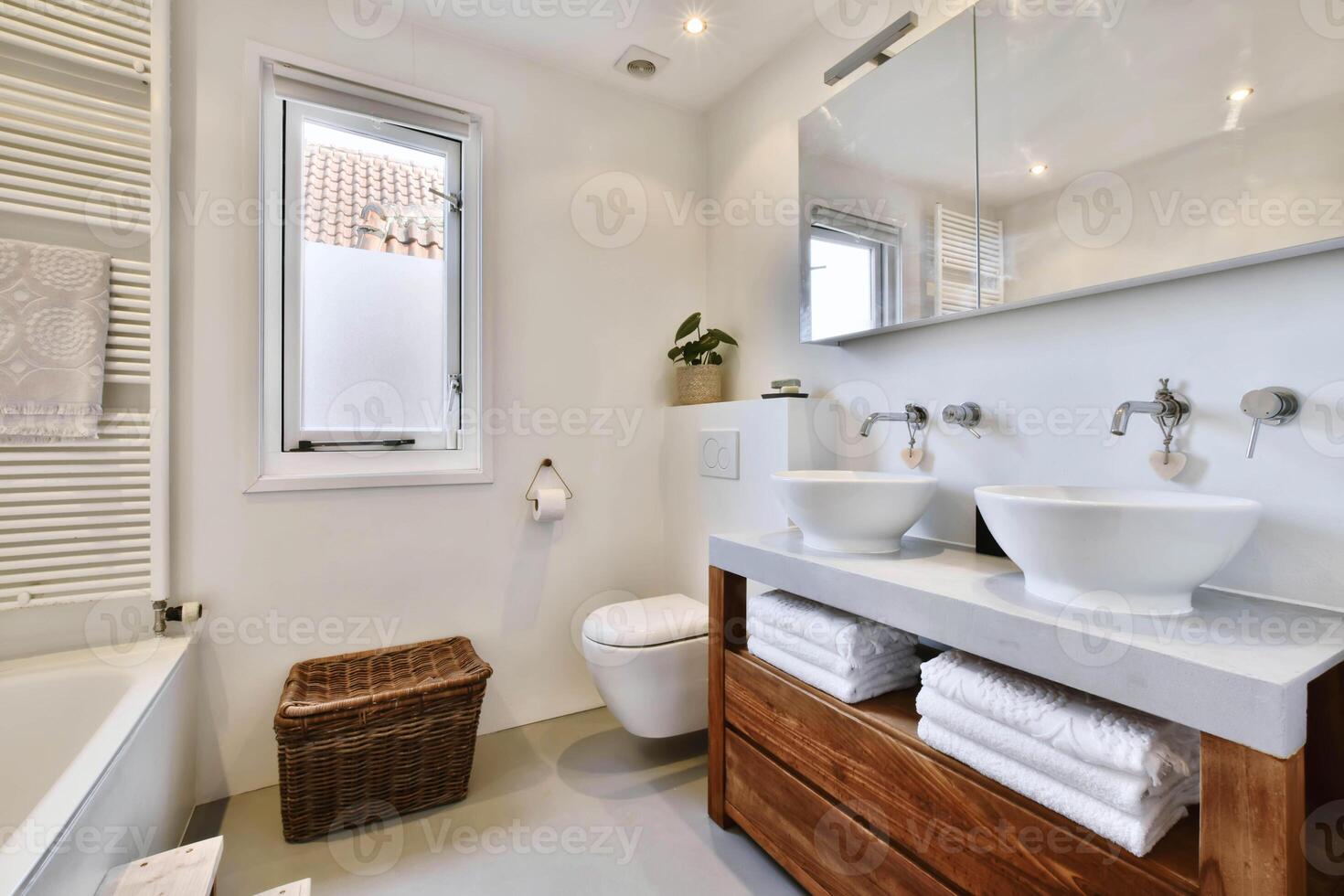 A clean bathroom with a sink, toilet and tub photo