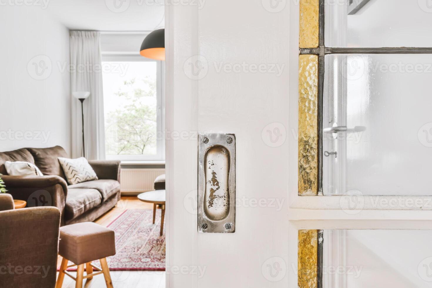A view of a living room with a door open photo