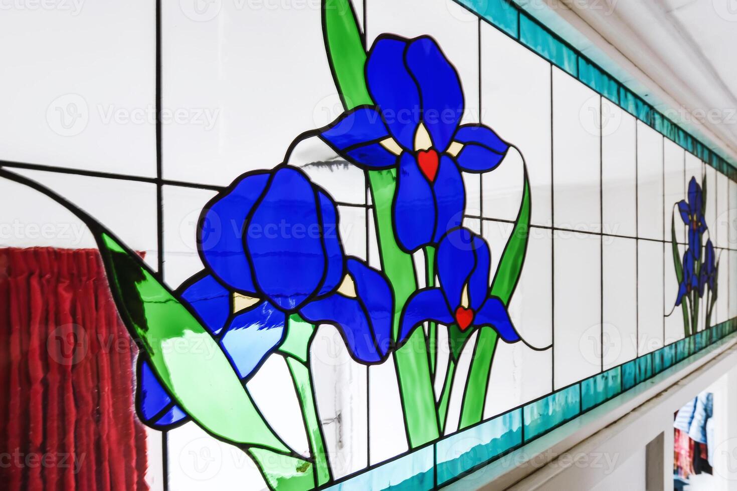 A stained glass window with blue flowers photo