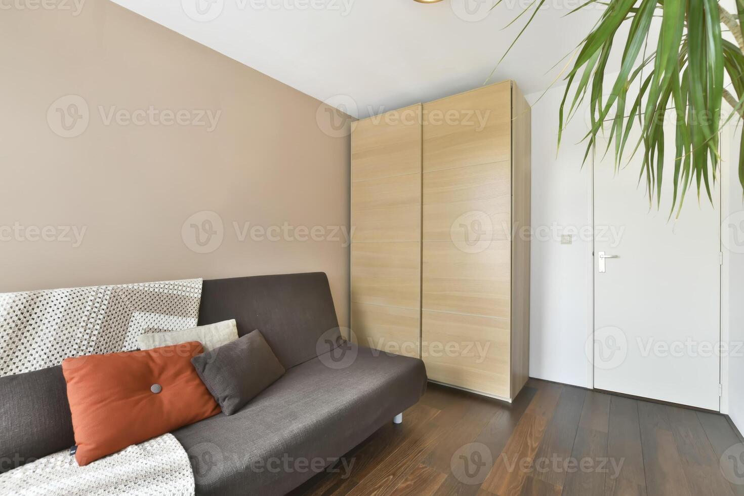 A room with a couch and a wooden cabinet photo