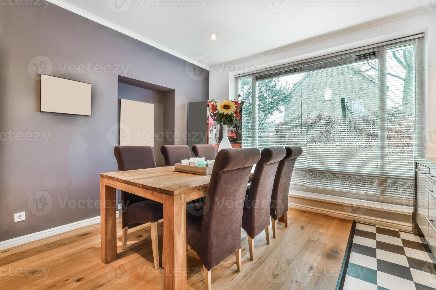 A dining room with a table and chairs photo