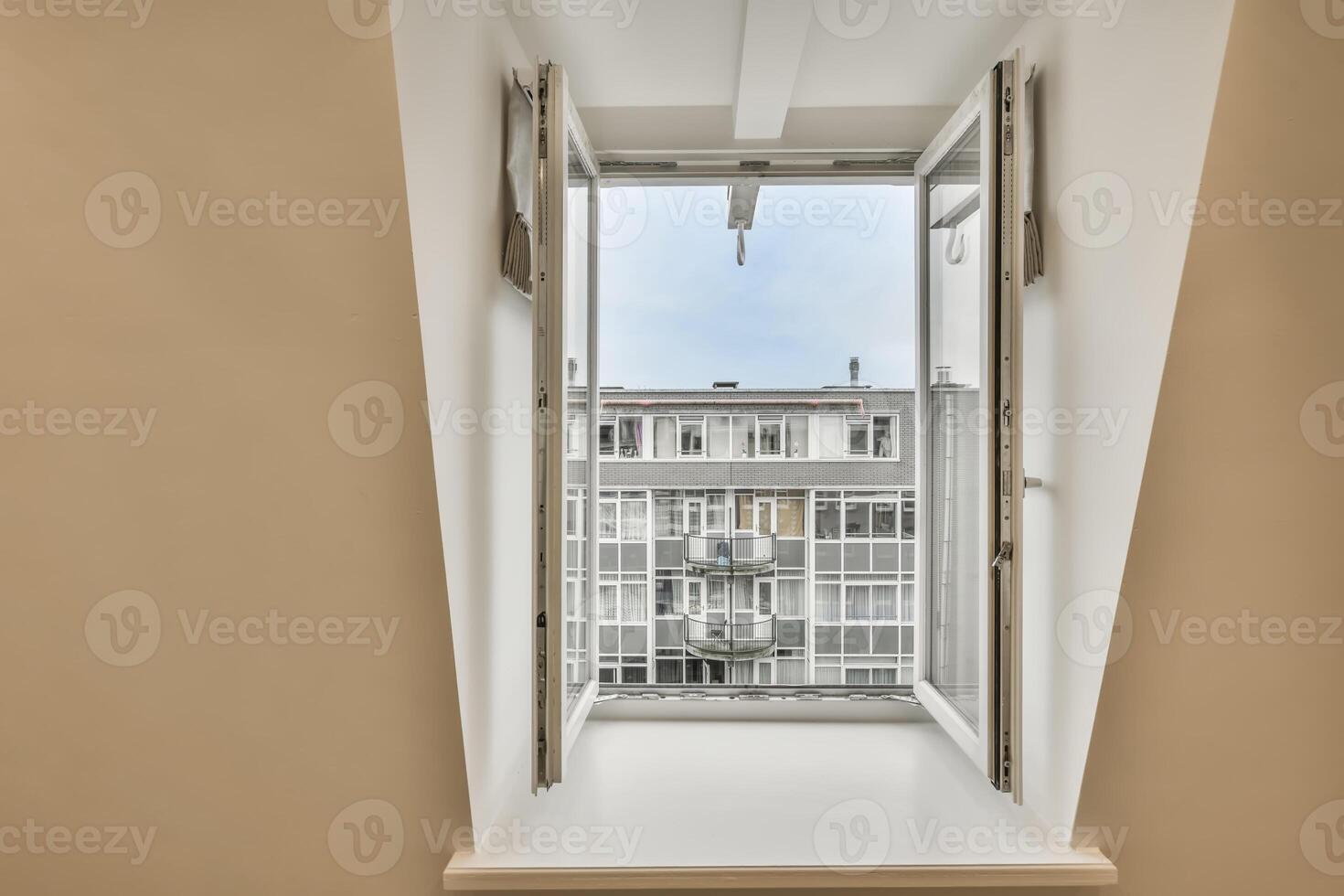 A window with an open door and a view of a building photo