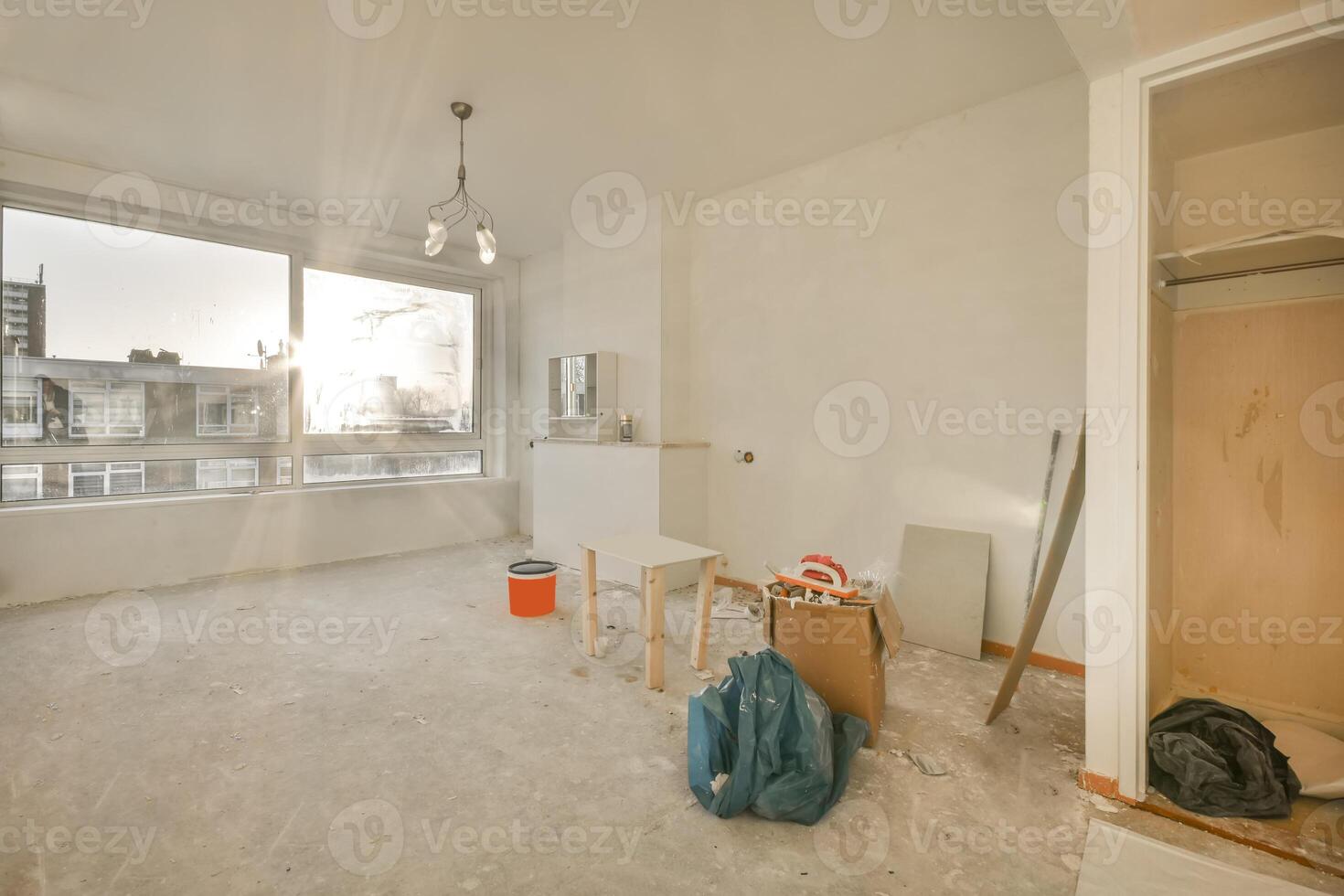 A room with a window and a lot of construction materials photo