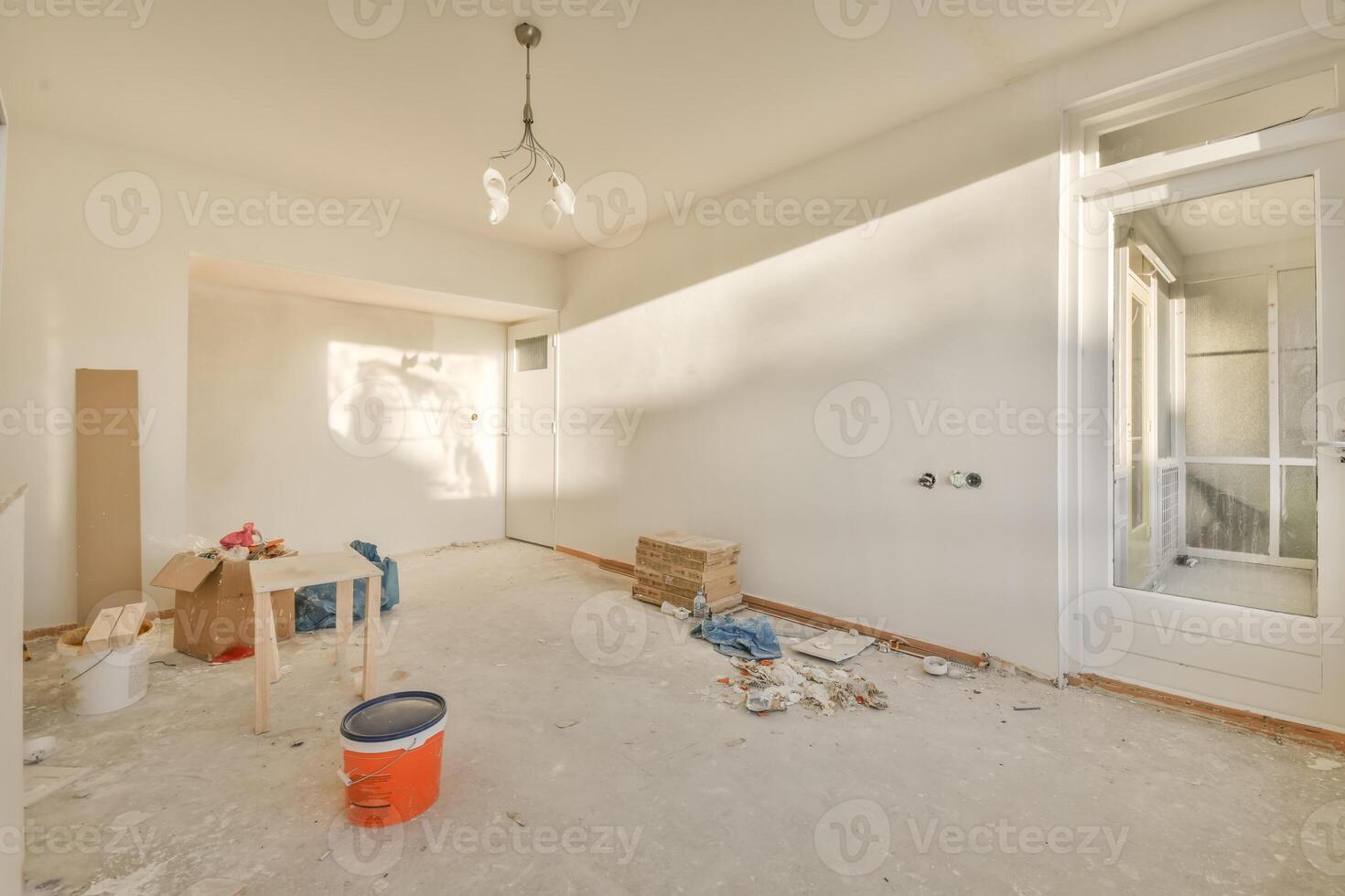 An empty room with a door and a table photo