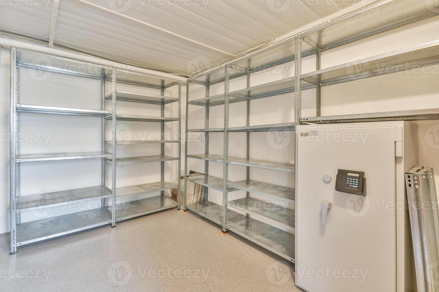 A large room with shelves and a refrigerator photo