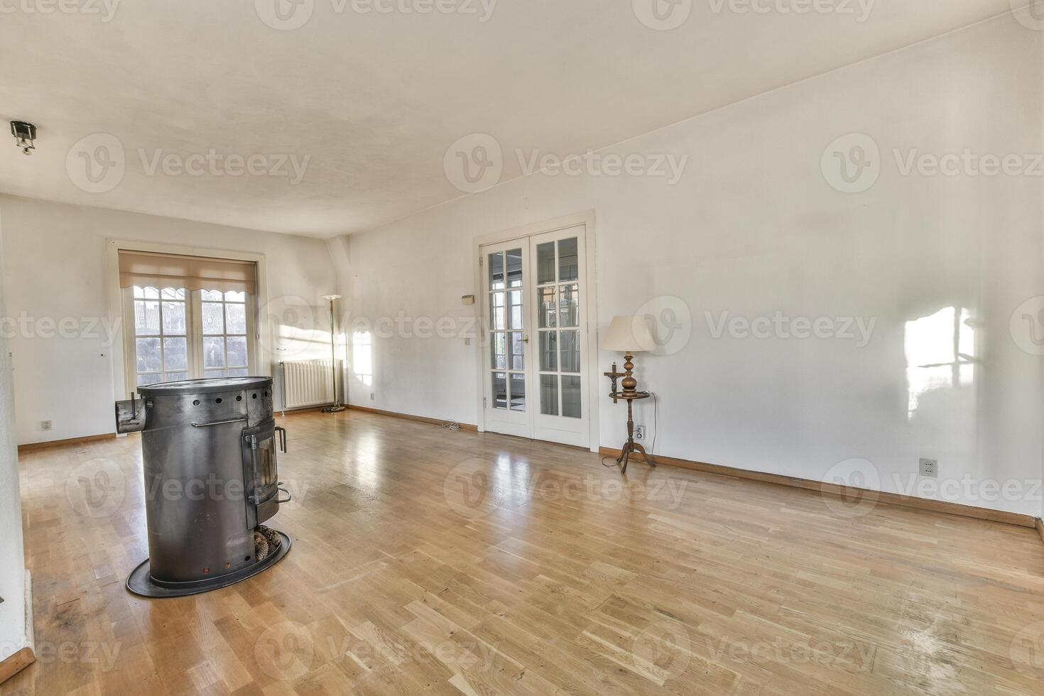A room with hardwood floors and a fireplace photo