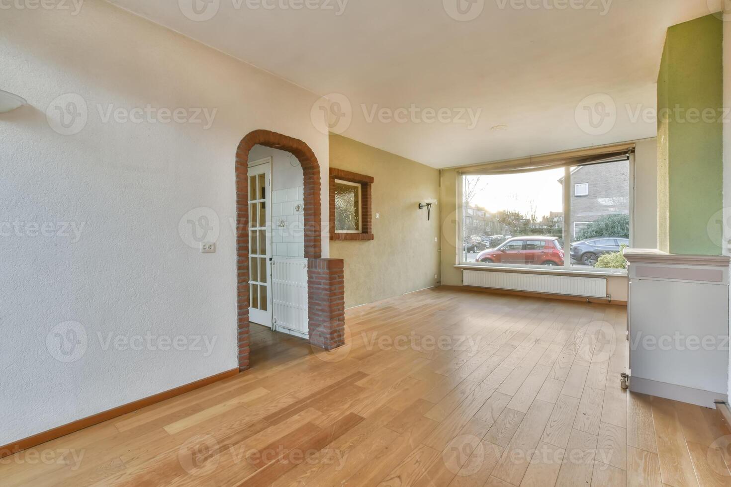 A room with hardwood floors and a window photo