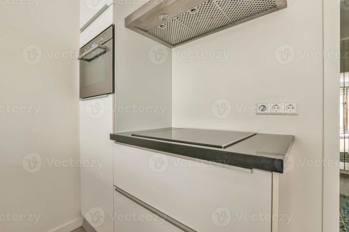 A small kitchen with a stove and oven photo