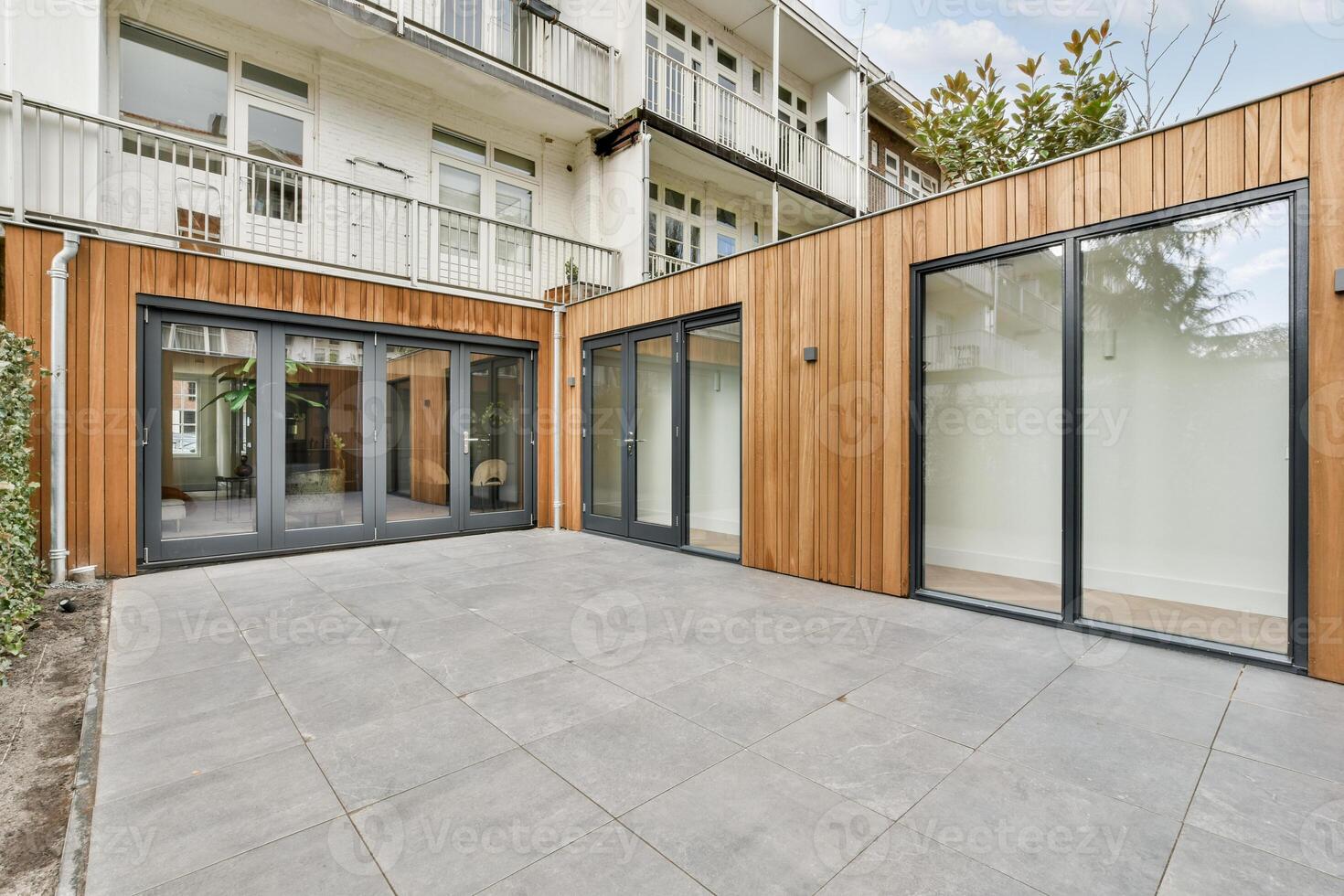 A patio with sliding doors and wooden walls photo