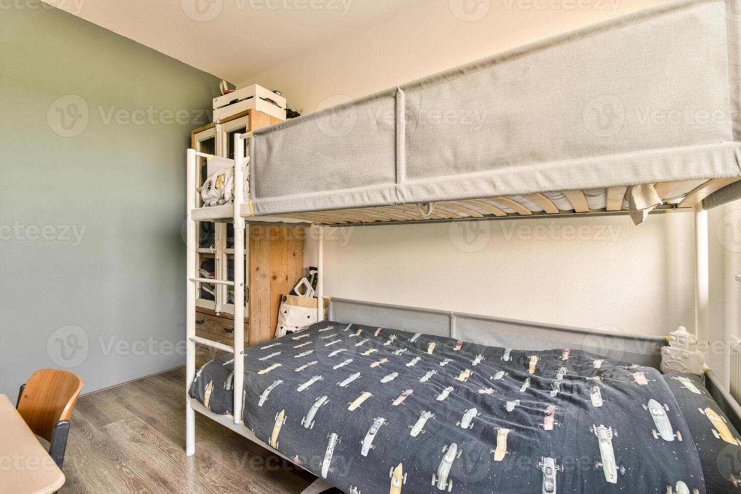 A bunk bed with a desk and a bed in a bedroom photo