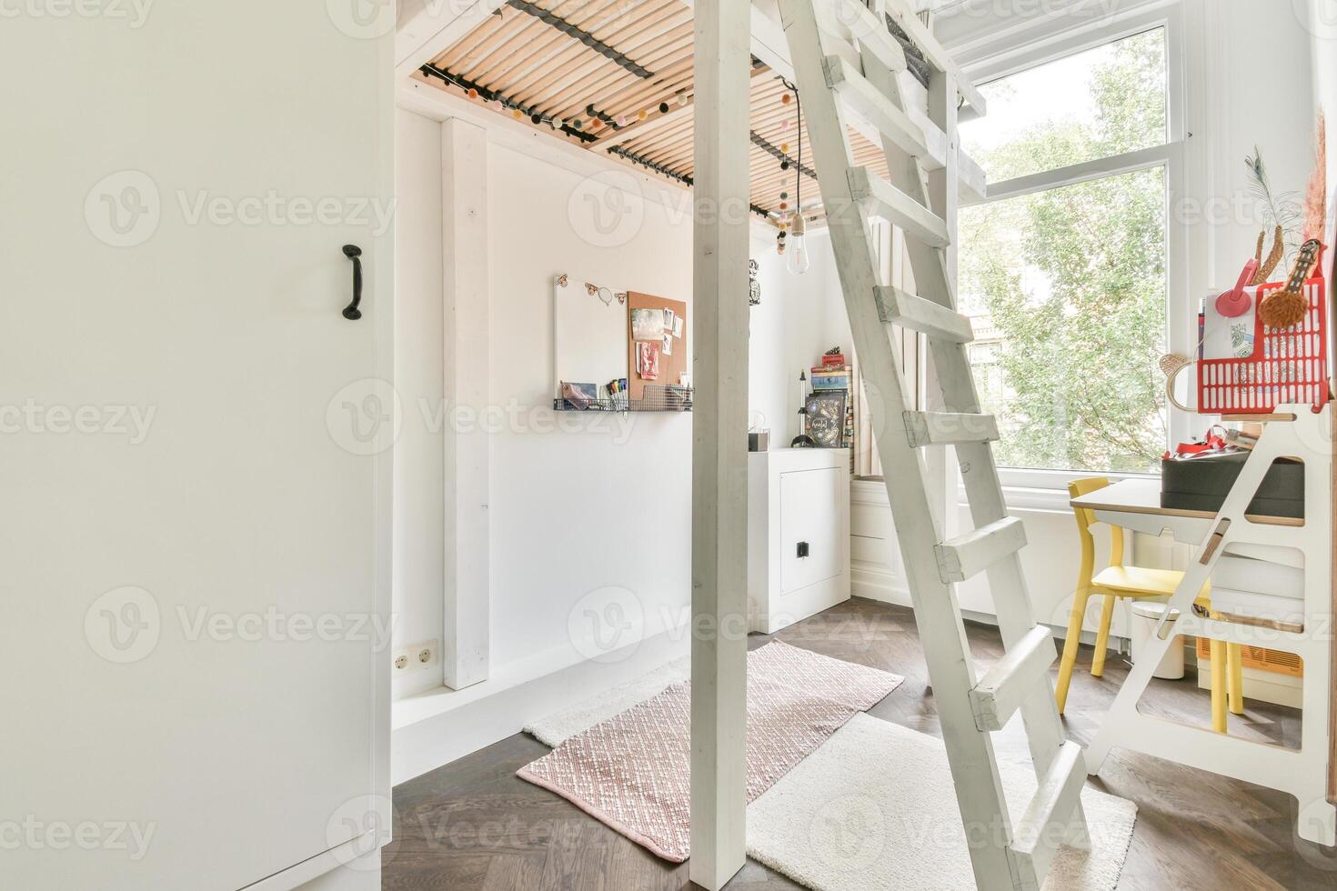 A loft bed with a ladder and a desk in a small room photo