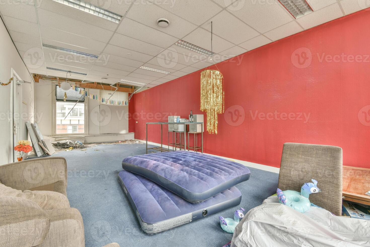 A room with a bed, a couch, and a mattress photo