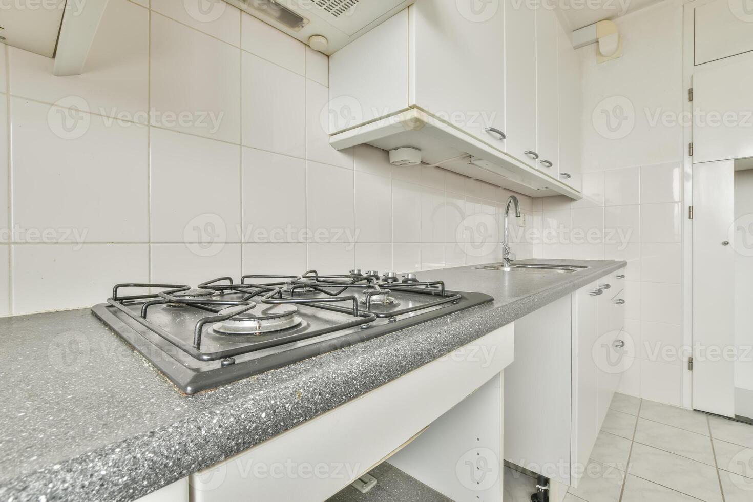 A kitchen with a stove and oven in it photo
