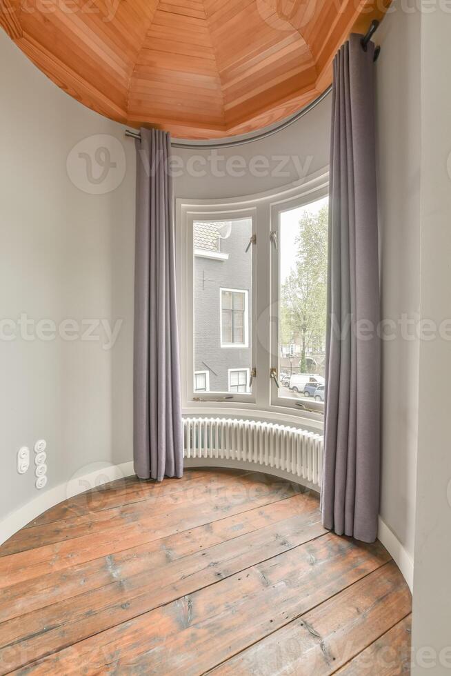 A room with a wooden floor and a round window photo