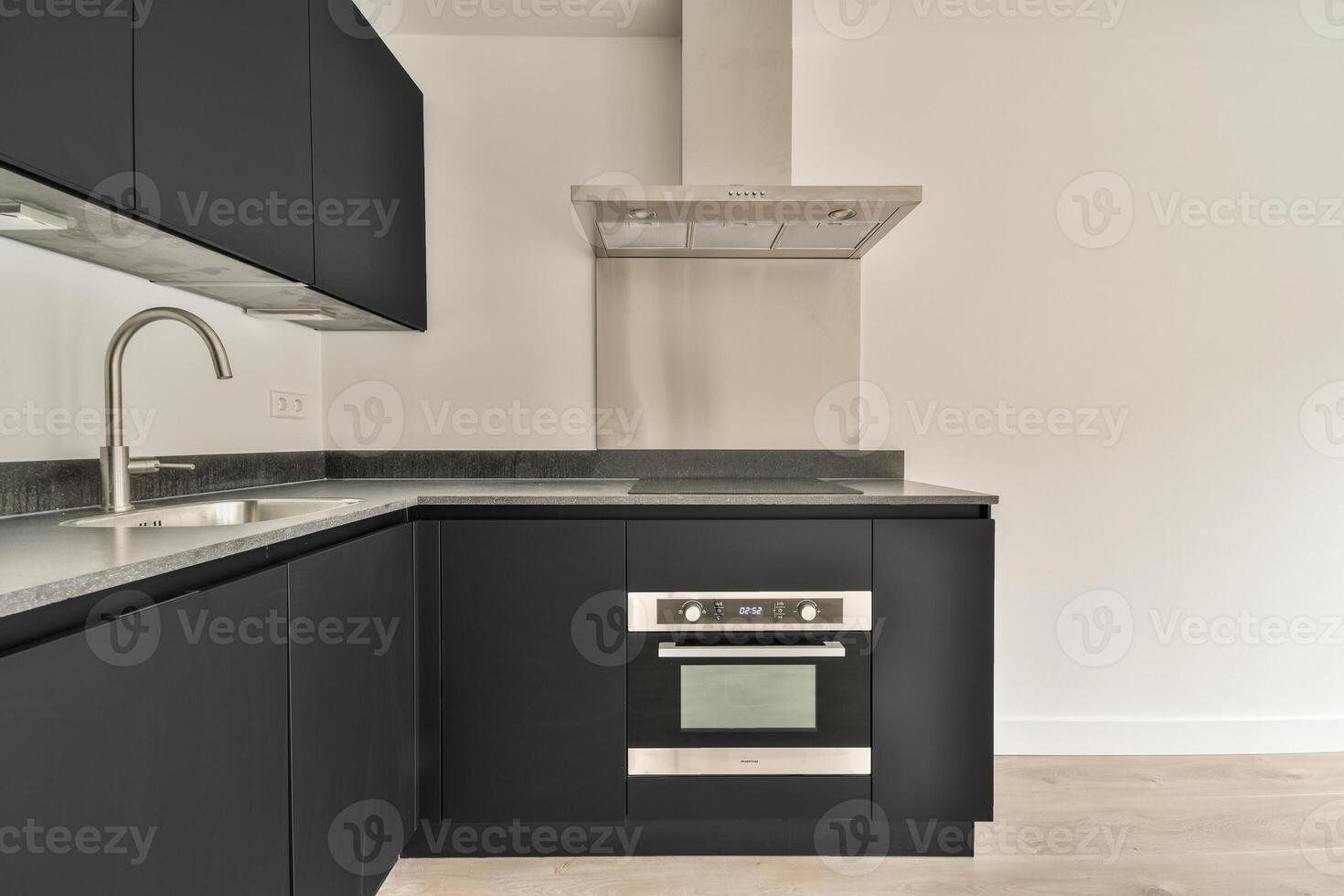 A black kitchen with stainless steel appliances and a microwave photo