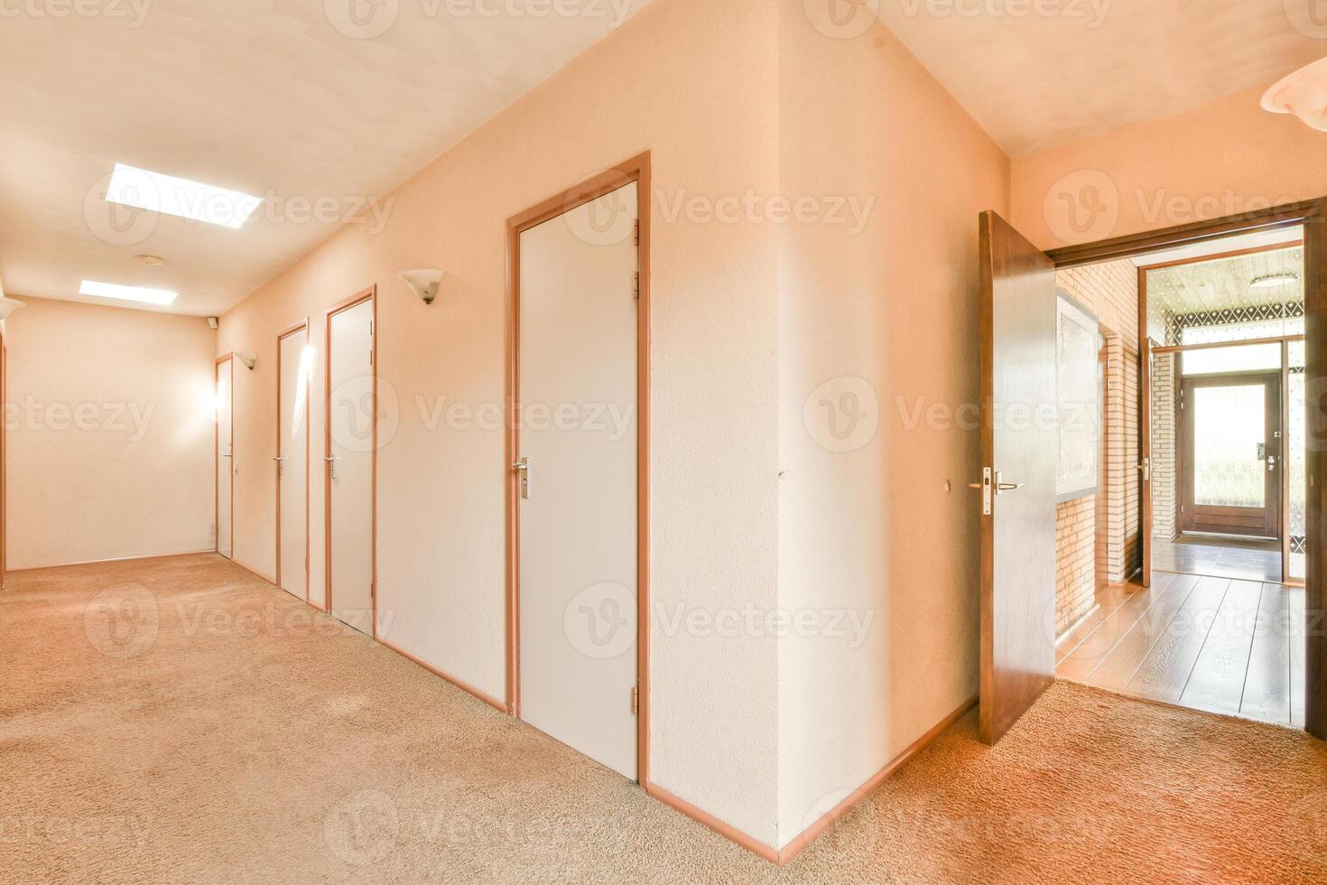 A hallway with a door and a window photo