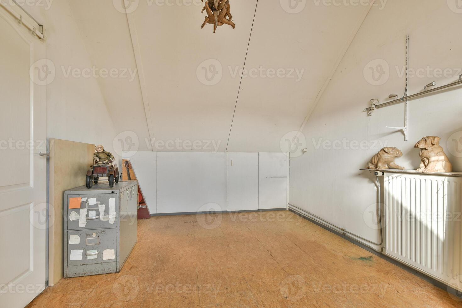 A room with a radiator and a bunch of stuffed animals photo