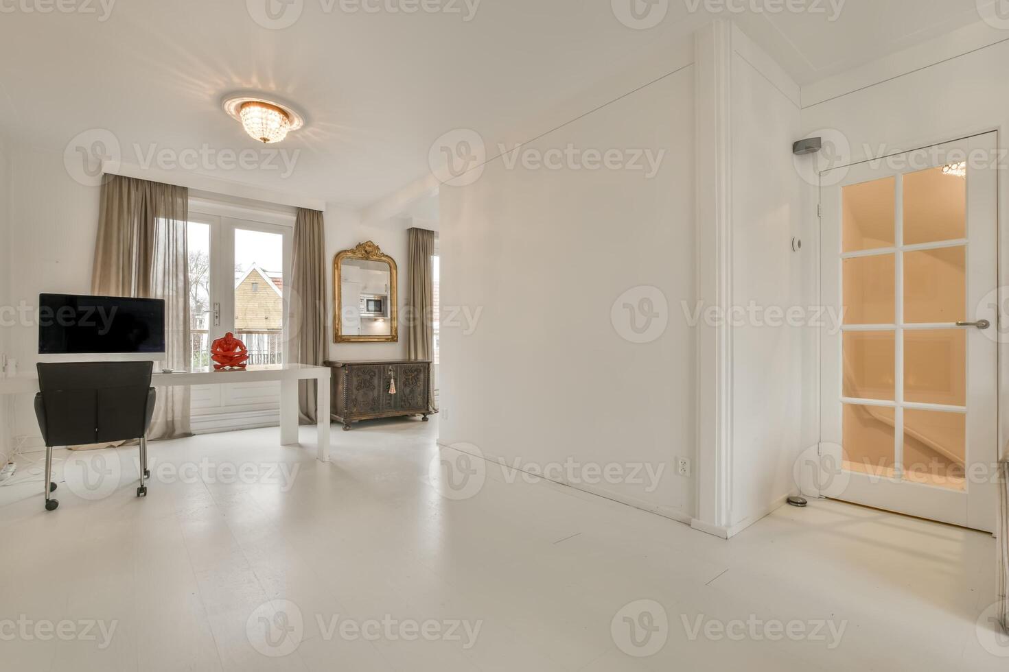 A white room with a desk, chair and a window photo