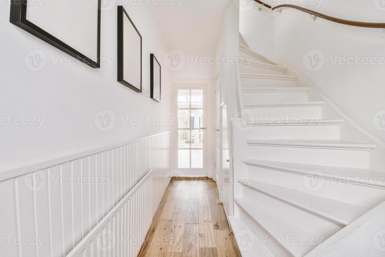 A white staircase in a home with wooden floors photo