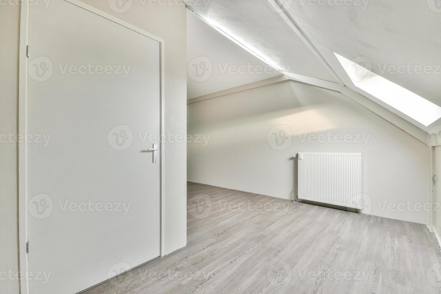 Empty room with white walls and wooden floors photo