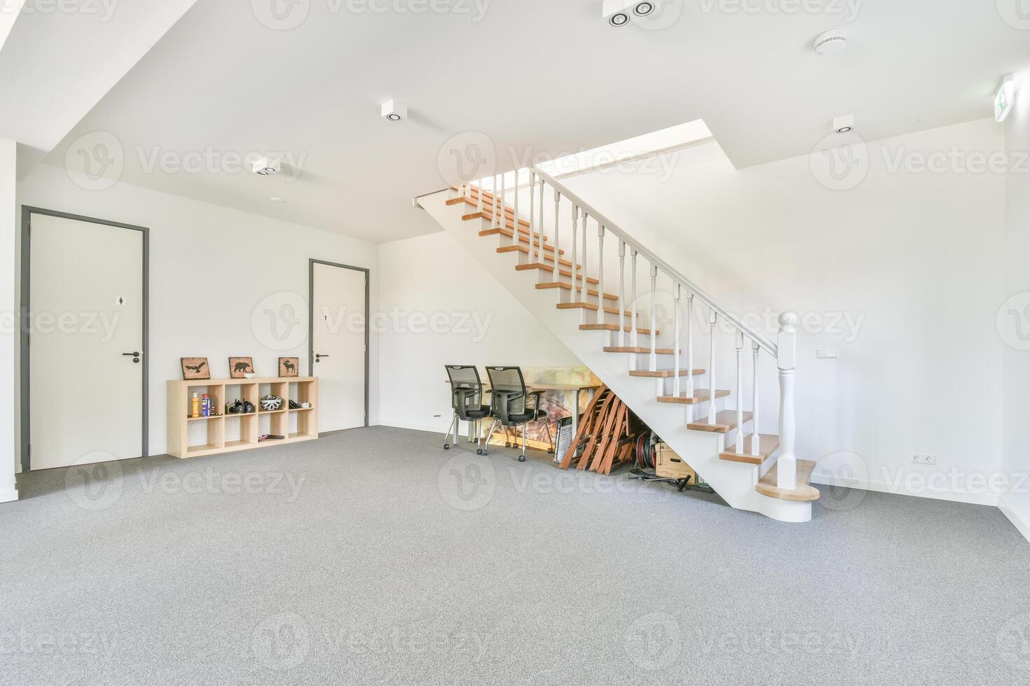 A room with stairs and a white wall photo
