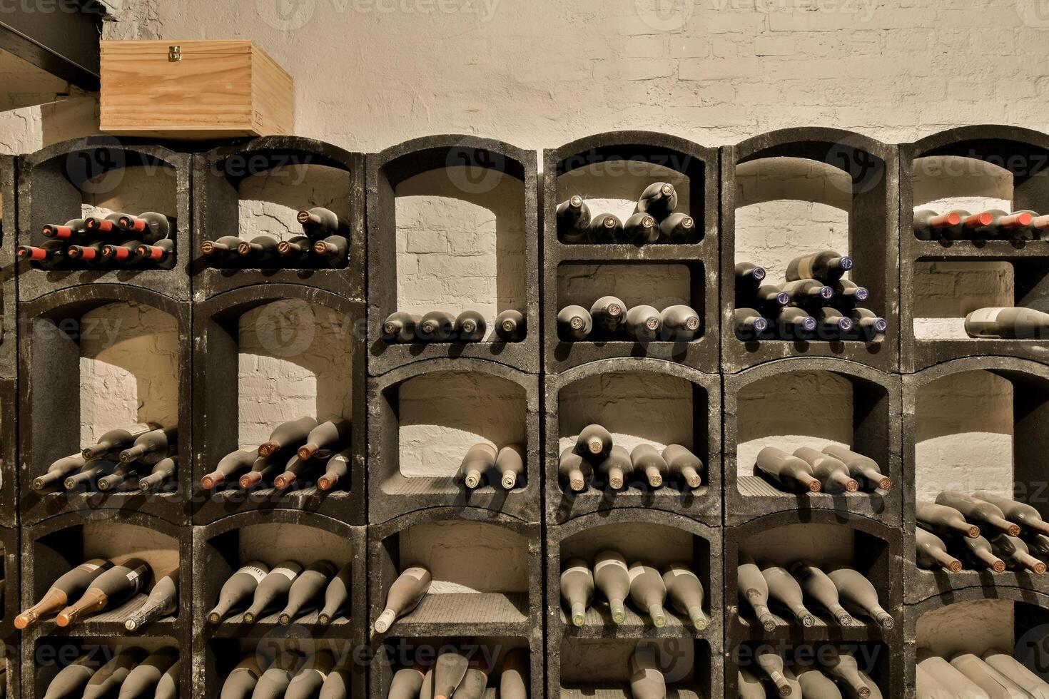 A wine rack with many bottles on it photo