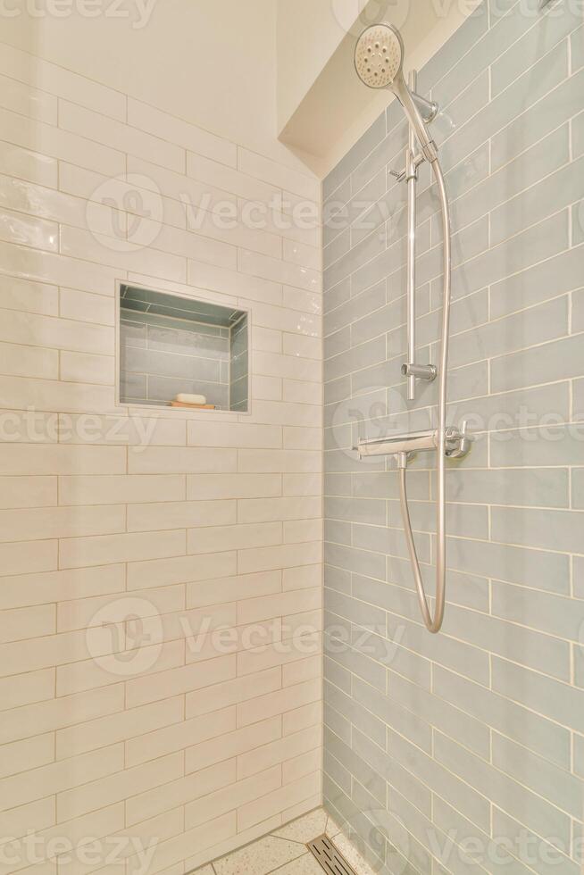 A shower with a shower head and a shower stall photo