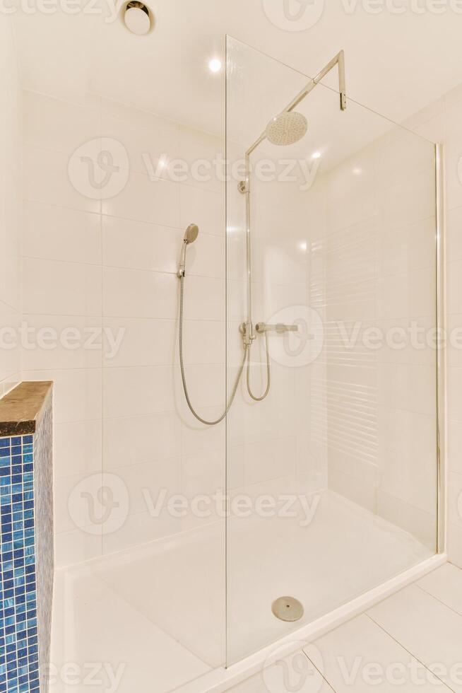A walk in shower with a glass door photo