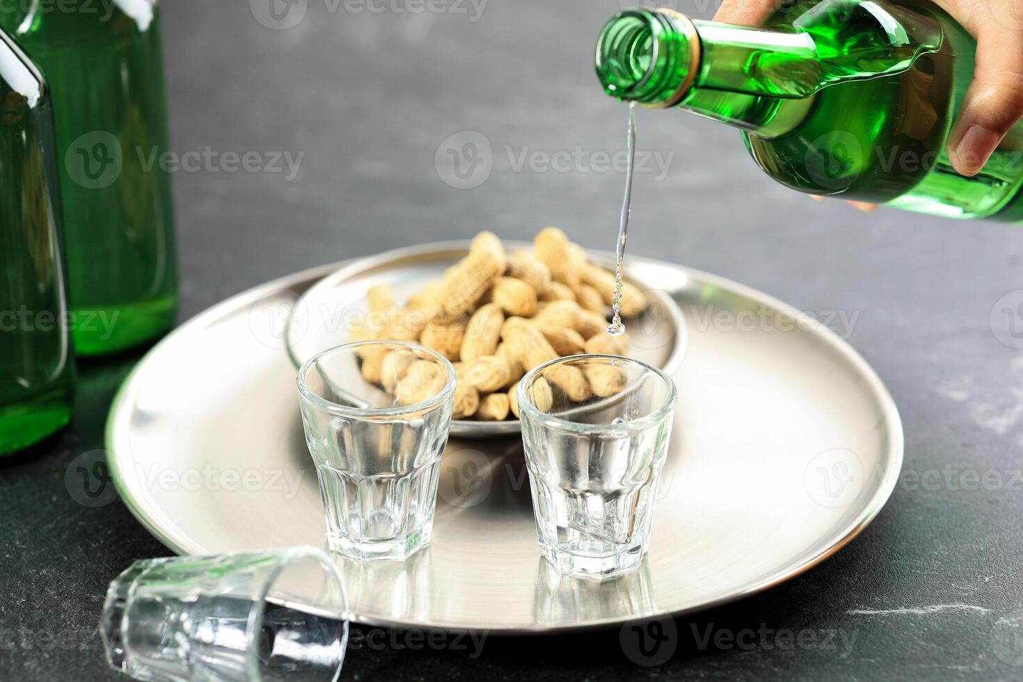 Pouring Soju Water Korean Alcohol to Small Glass photo