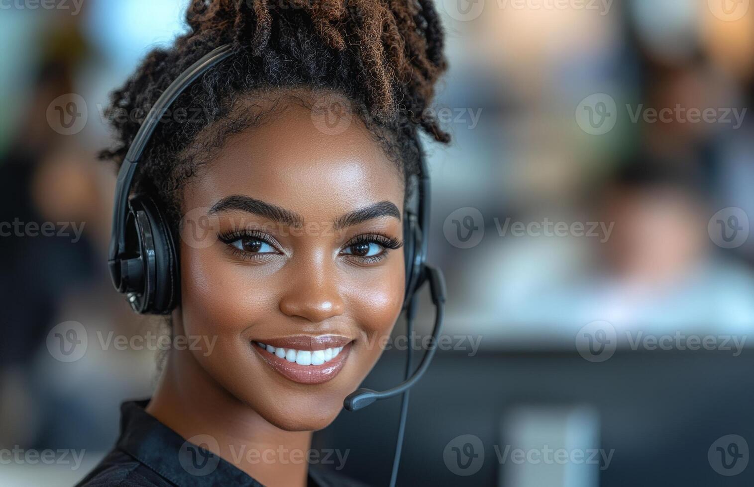 Smiling Black woman call center worker wearing a headset, working on a computer, communicating photo
