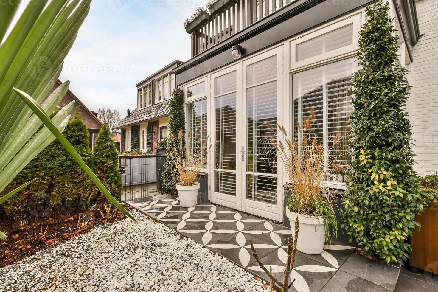 A house with a patio and a garden photo