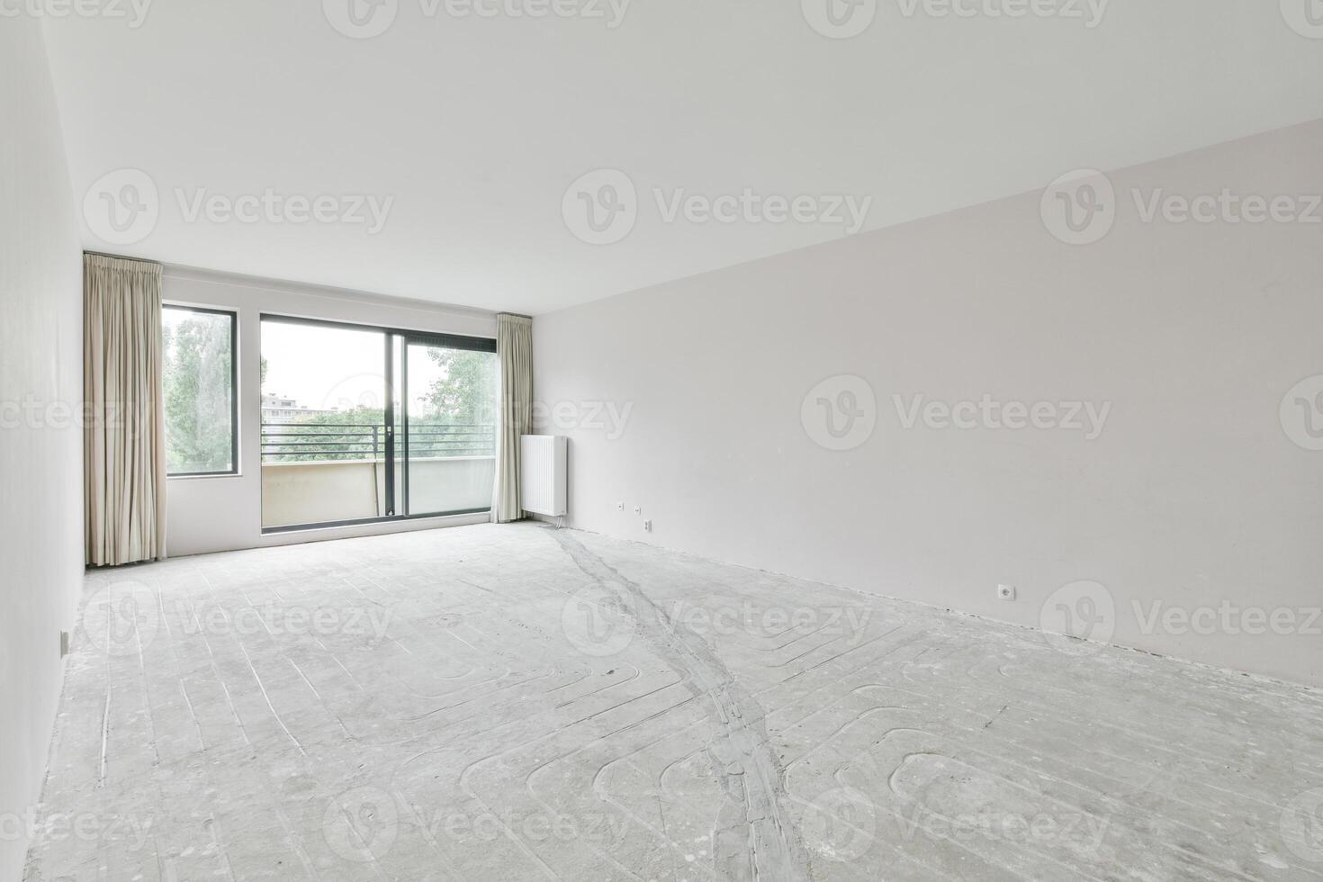 Empty room with white walls and large windows photo