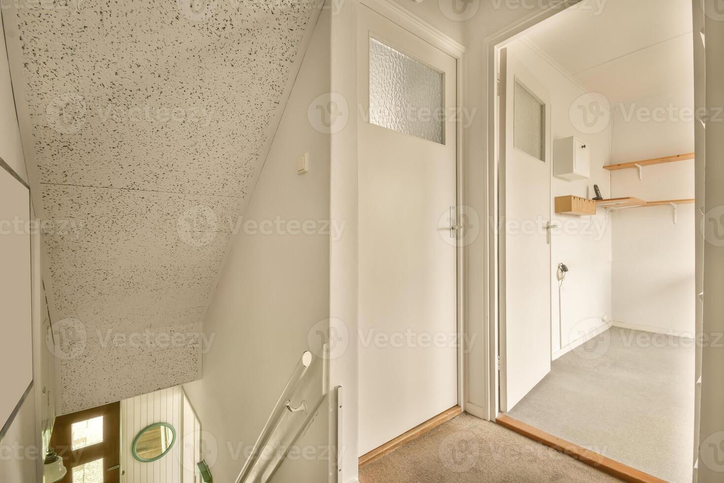 A hallway with a door and a shelf photo