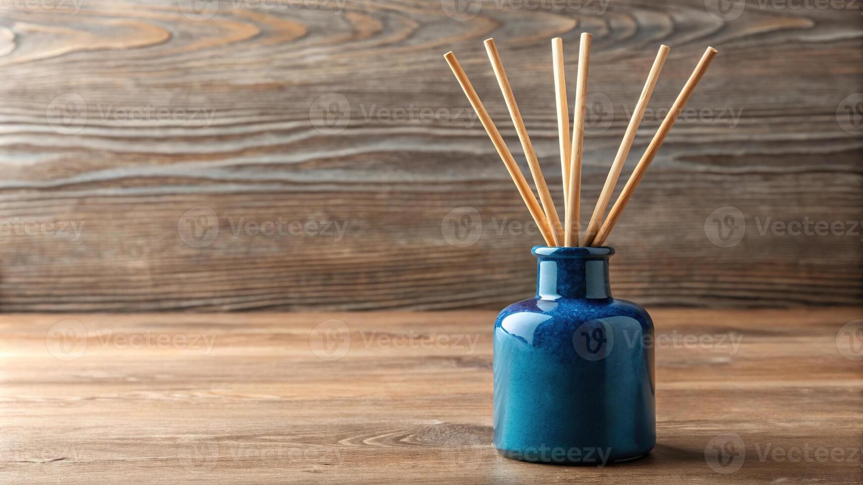 A blue ceramic diffuser bottle with wooden reeds aerial view photo